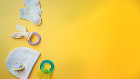 Accessories for newborns on a yellow background. Selective focus. Baby.の写真素材