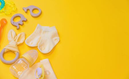 Accessories for newborns on a yellow background. Selective focus. Baby.の写真素材