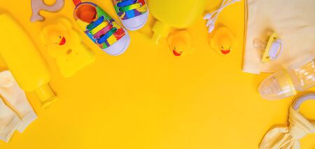 Accessories for newborns on a yellow background. Selective focus. Baby.の写真素材