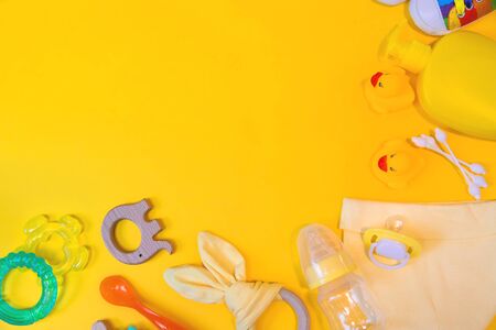 Accessories for newborns on a yellow background. Selective focus. Baby.の写真素材