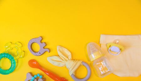 Accessories for newborns on a yellow background. Selective focus. Baby.