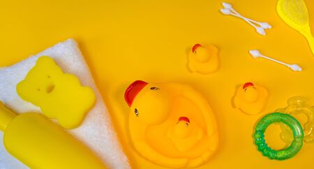 Accessories for bathing newborns on a yellow background. Selective focus. Baby.の写真素材