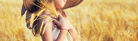 A child in a wheat field. Selective focus.の写真素材