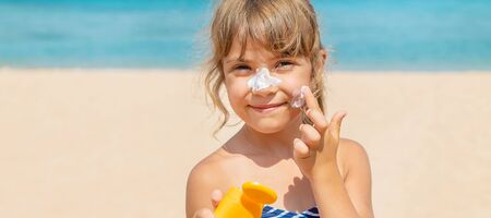 Sunscreen on the skin of a child. Selective focus.
