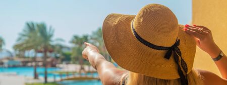 girl looks at the pool and sea. Selective focus. nature.
