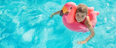 the child swims and dives in the pool. Selective focus.