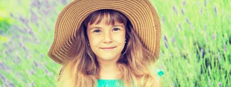 A child in a flowering field of lavender. Selective focus.の写真素材