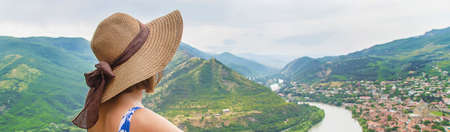 Woman traveler on the background of the attractions of Georgia. Near the monastery Jvari. Selective...