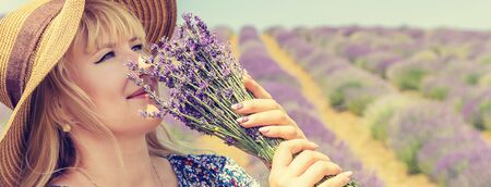 Girl in a flowering field of lavender. Selective focus. nature.の写真素材