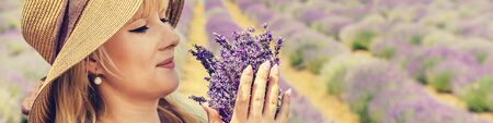Girl in a flowering field of lavender. Selective focus. nature.の写真素材
