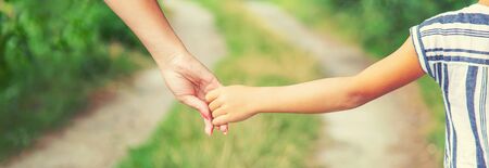 child goes hand in hand with his mother. Selective focus. nature.の写真素材