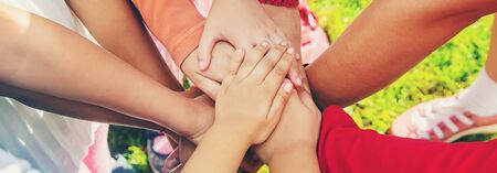 children folded their hands together, play on the street. Selective focus. nature.