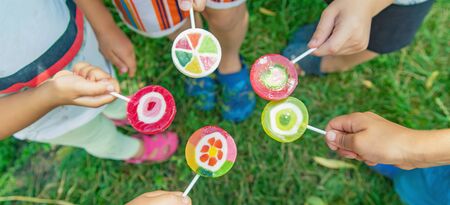 Lollipops in the hands of children. Selective focus. nature.の写真素材