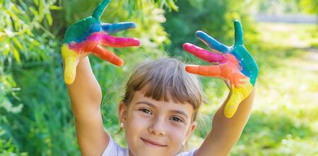 child with painted hands and legs. Selective focus.の写真素材