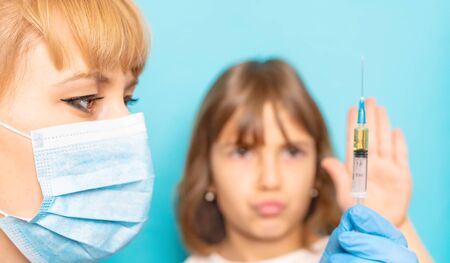 The child is injected into the arm. Selective focus.の写真素材