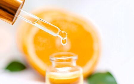 Orange essential oil on a white isolated background. Selective focus. food.の写真素材