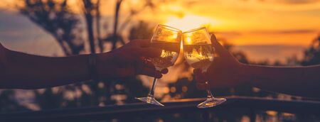 With glasses of wine at sunset. Selective focus. Drink.の写真素材