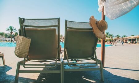 Sun loungers and a hat near the pool. Resort. Selective focus. nature.の写真素材