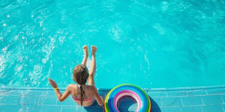 the child swims and dives in the pool. Selective focus. nature.