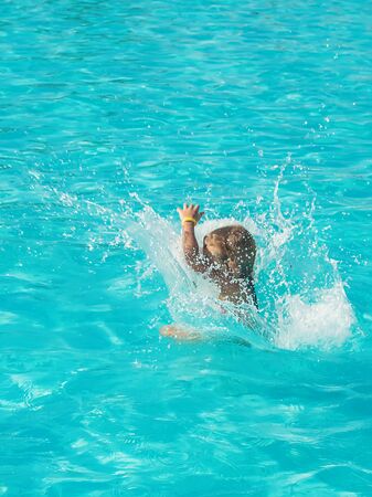 The child jumps into the pool. Selective focus. nature.の写真素材