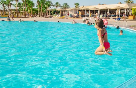 The child jumps into the pool. Selective focus.の写真素材