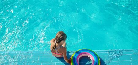 the child swims and dives in the pool. Selective focus. nature.