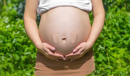 Belly of a pregnant woman legs baby. Selective focus. Selective focus. people.