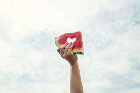 A child on a picnic eats a watermelon. Selective focus. Food.