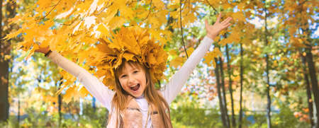 Children in the park with autumn leaves. Selective focus.