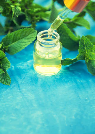 Peppermint essential oil in a small bottle. Selective focus. nature.の写真素材