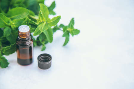 Peppermint essential oil in a small bottle. Selective focus. nature.の写真素材