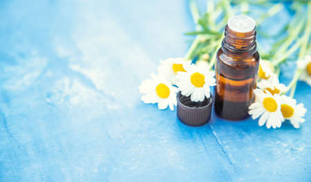 Chamomile essential oil in a small bottle. Selective focus. nature.の写真素材