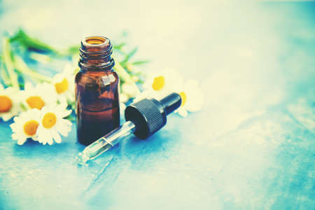 Chamomile essential oil in a small bottle. Selective focus. nature.の写真素材
