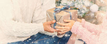 people with Christmas gifts in their hands. selective focus. happy.