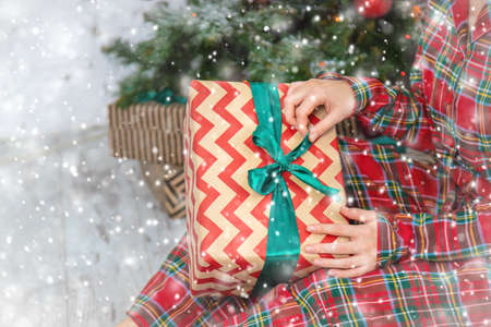 people with Christmas gifts in their hands. selective focus. happy.