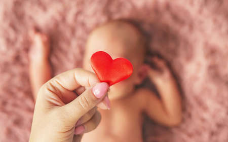 newborn baby and mom's hands. selective focus. people.の写真素材