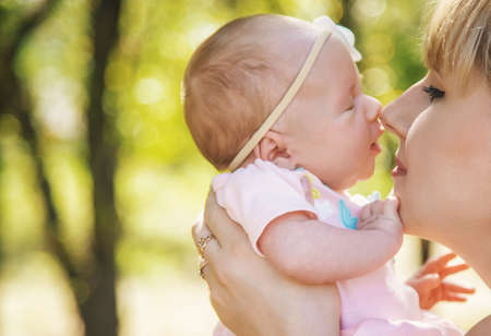 Mom is holding a newborn baby in nature. Selective focus. People.の写真素材