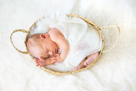 Newborn baby sleeping on a white background. Selective focus. people.の写真素材