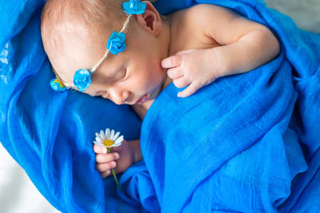 Newborn baby sleeping on a blue background. Selective focus. people.の写真素材