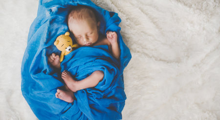 A newborn baby sleeps with a teddy bear. Selective focus. people.の写真素材