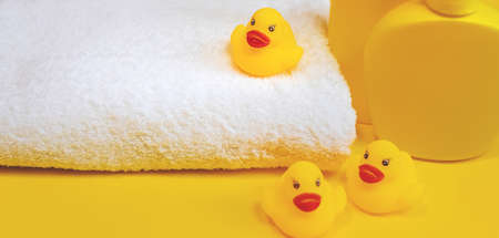 Accessories for bathing newborns on a yellow background. Selective focus. Baby.の写真素材