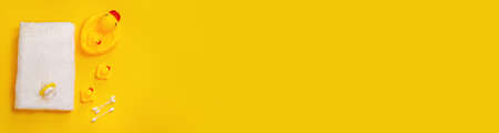 Accessories for bathing newborns on a yellow background. Selective focus. Baby.の写真素材