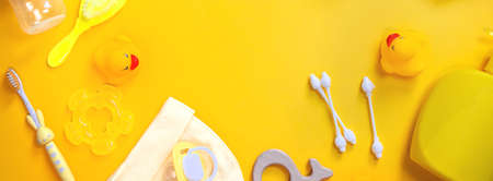 Accessories for newborns on a yellow background. Selective focus. Baby.