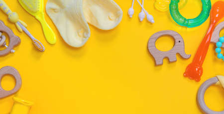 Accessories for newborns on a yellow background. Selective focus. Baby.の写真素材