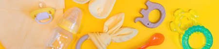 Accessories for newborns on a yellow background. Selective focus. Baby.