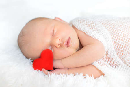 Newborn baby sleeping on a white background. Selective focus. people.の写真素材