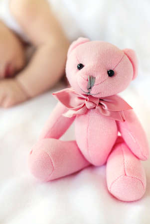Baby sleeps with a teddy bear on a white background. Selective focus. People.の写真素材