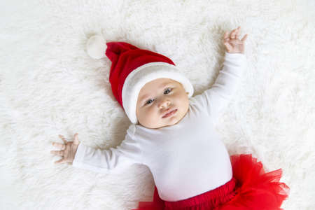 Baby dressed as Santa Claus. Christmas. Selective focus. People.
