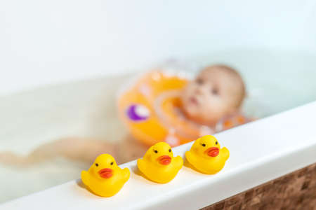 Baby is swimming in the bathroom. Selective focus. People.の写真素材