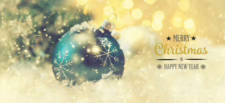 Merry Christmas and Happy New Year, Holidays greeting card with blurred bokeh background.